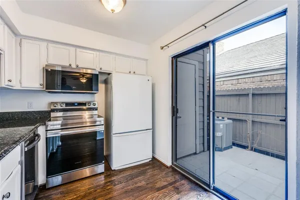 a kitchen with a refrigerator stove and microwave