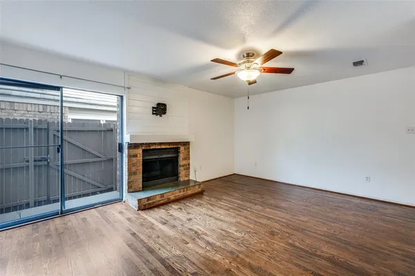 wooden floor fireplace and natural light in room