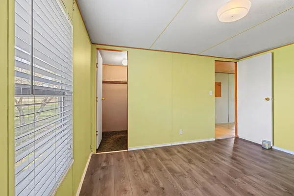 a view of hallway with wooden floor