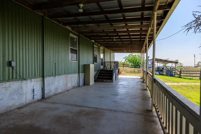 a view of a porch with wooden floor