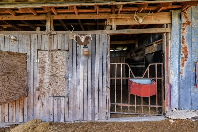 a room with table chair and white walls