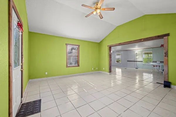 a view of a room with window a ceiling fan and refrigerator