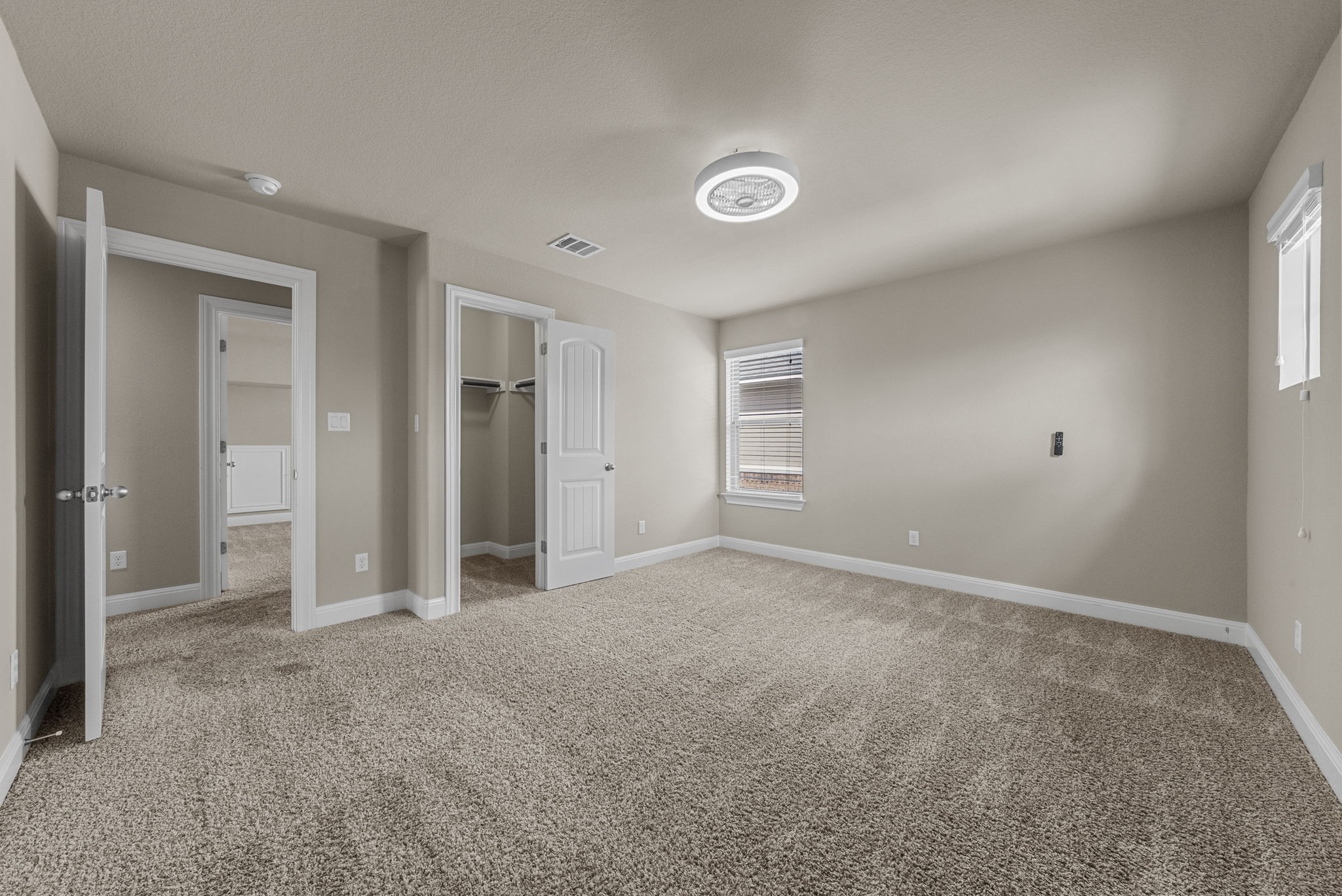 4401 Trinity Woods Street Leander, TX 78641 - Photo 5 of 37 An airy bedroom with soft carpeting and ample natural light awaits your personal touch.