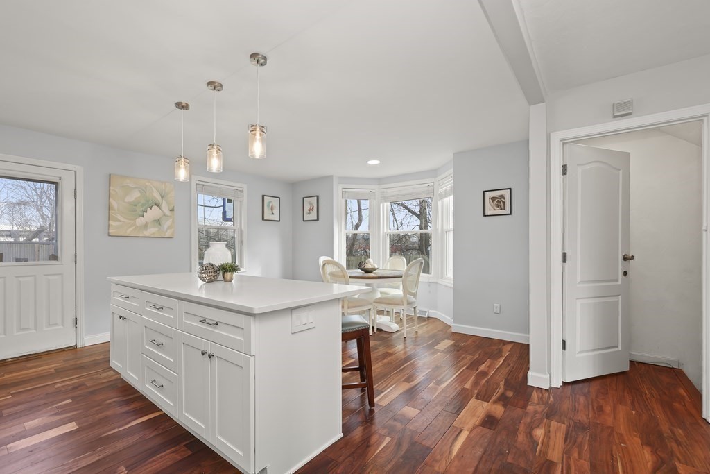 4 Rowe Court, Unit 4 Boston, MA 02131 - Photo 12 of 41 a view of cabinets a island wooden floor and a workspace