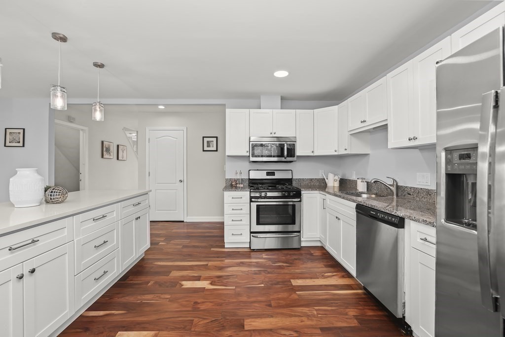 4 Rowe Court, Unit 4 Boston, MA 02131 - Photo 14 of 41 a large kitchen with stainless steel appliances and cabinets