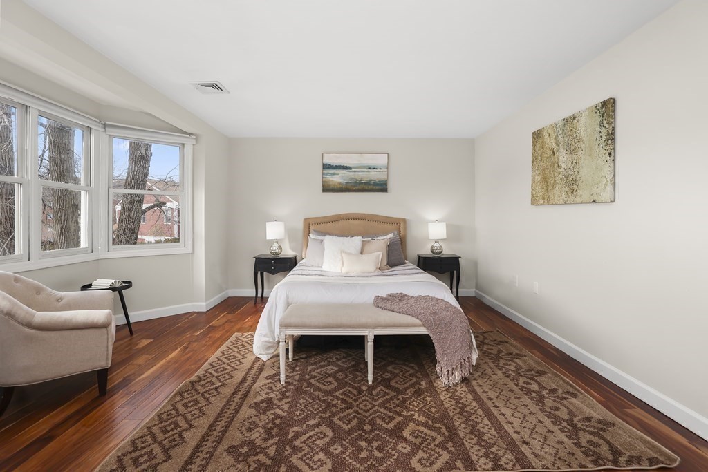 4 Rowe Court, Unit 4 Boston, MA 02131 - Photo 19 of 41 a bedroom with a bed and wooden floor