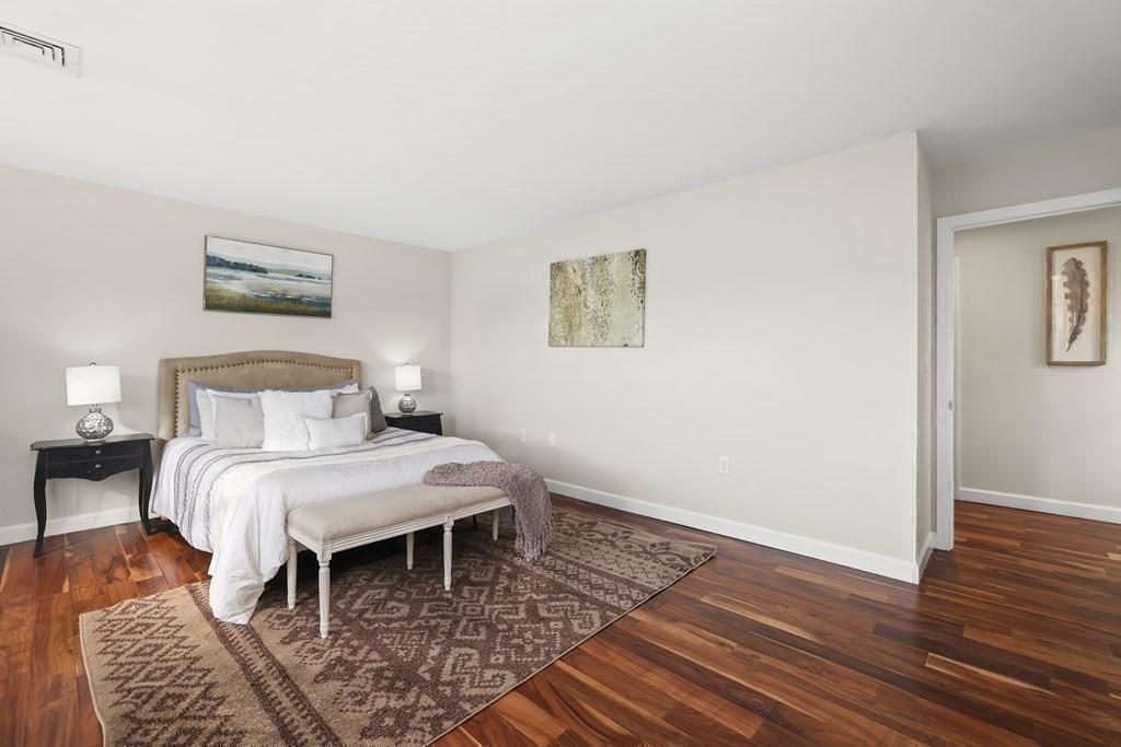 4 Rowe Court, Unit 4 Boston, MA 02131 - Photo 20 of 41 a bedroom with a bed and wooden floor