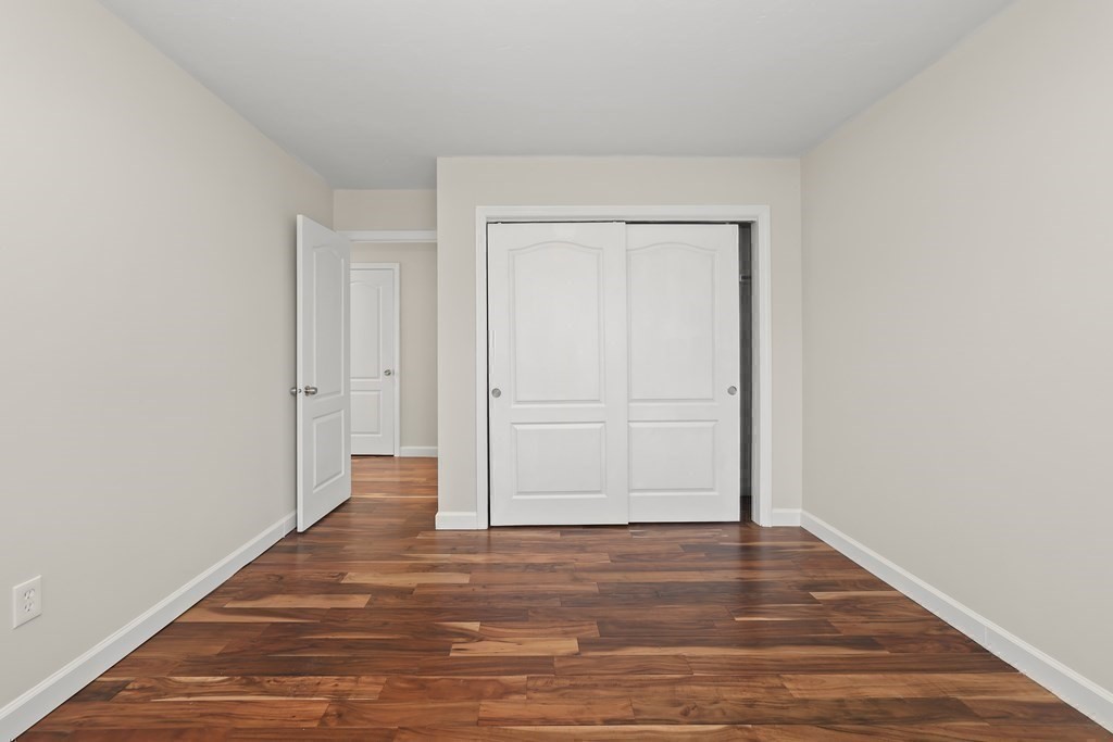 4 Rowe Court, Unit 4 Boston, MA 02131 - Photo 24 of 41 a view of an empty room with wooden floor