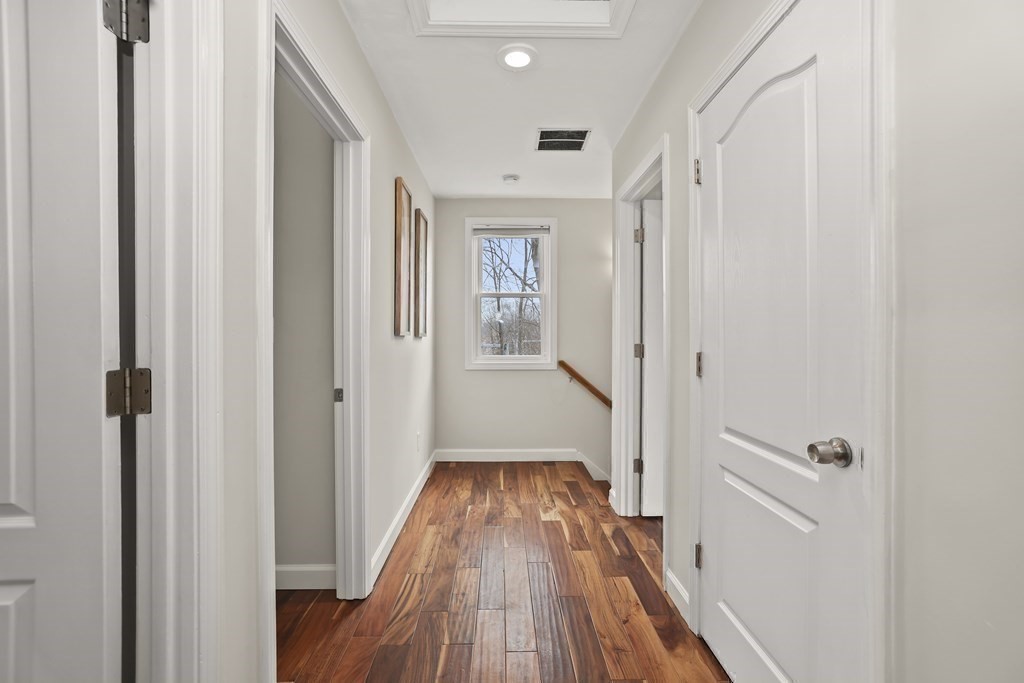 4 Rowe Court, Unit 4 Boston, MA 02131 - Photo 25 of 41 a view of a hallway with wooden floor and staircase