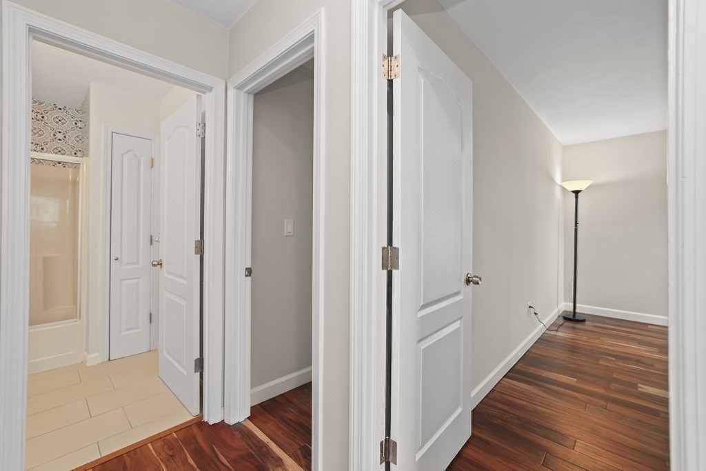 4 Rowe Court, Unit 4 Boston, MA 02131 - Photo 27 of 41 a view of a hallway with wooden floor and staircase