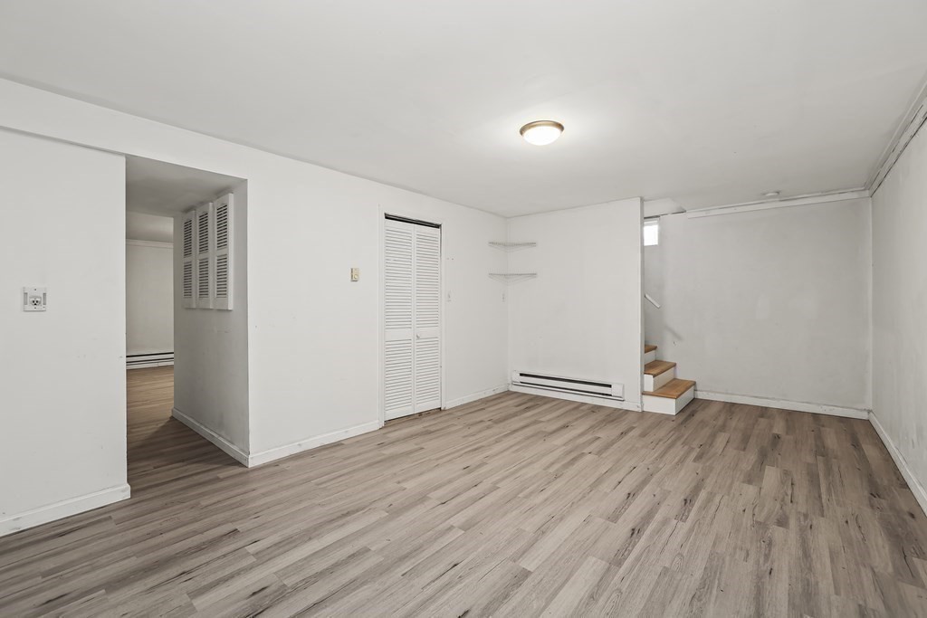 4 Rowe Court, Unit 4 Boston, MA 02131 - Photo 28 of 41 an empty room with wooden floor and windows