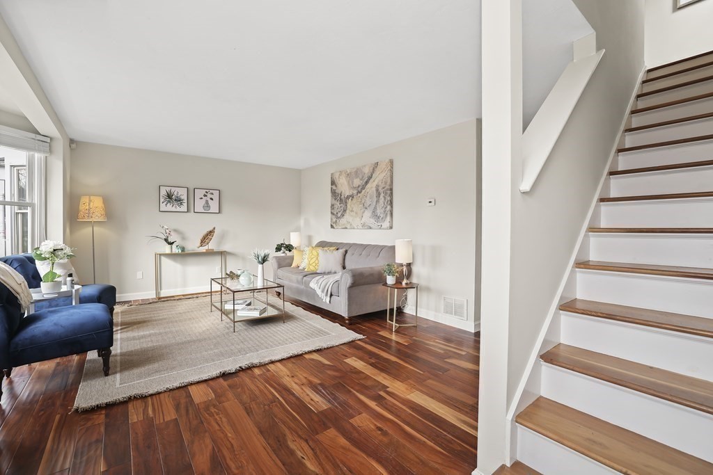 4 Rowe Court, Unit 4 Boston, MA 02131 - Photo 3 of 41 a living room with furniture and a wooden floor