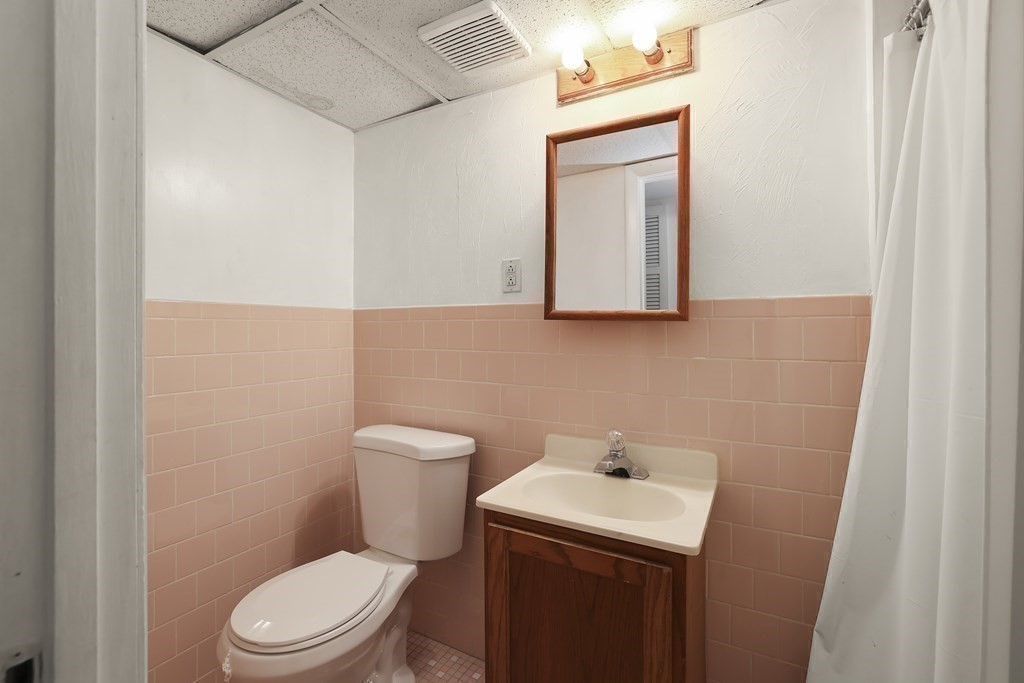 4 Rowe Court, Unit 4 Boston, MA 02131 - Photo 31 of 41 a bathroom with a toilet sink and mirror