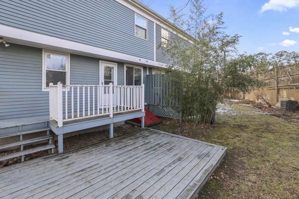 4 Rowe Court, Unit 4 Boston, MA 02131 - Photo 34 of 41 a backyard of a house with wooden floor and fence