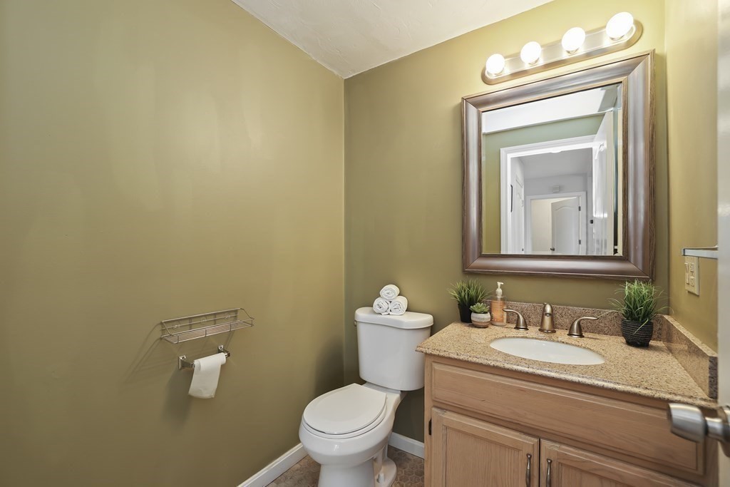4 Rowe Court, Unit 4 Boston, MA 02131 - Photo 9 of 41 a bathroom with a toilet sink vanity and mirror