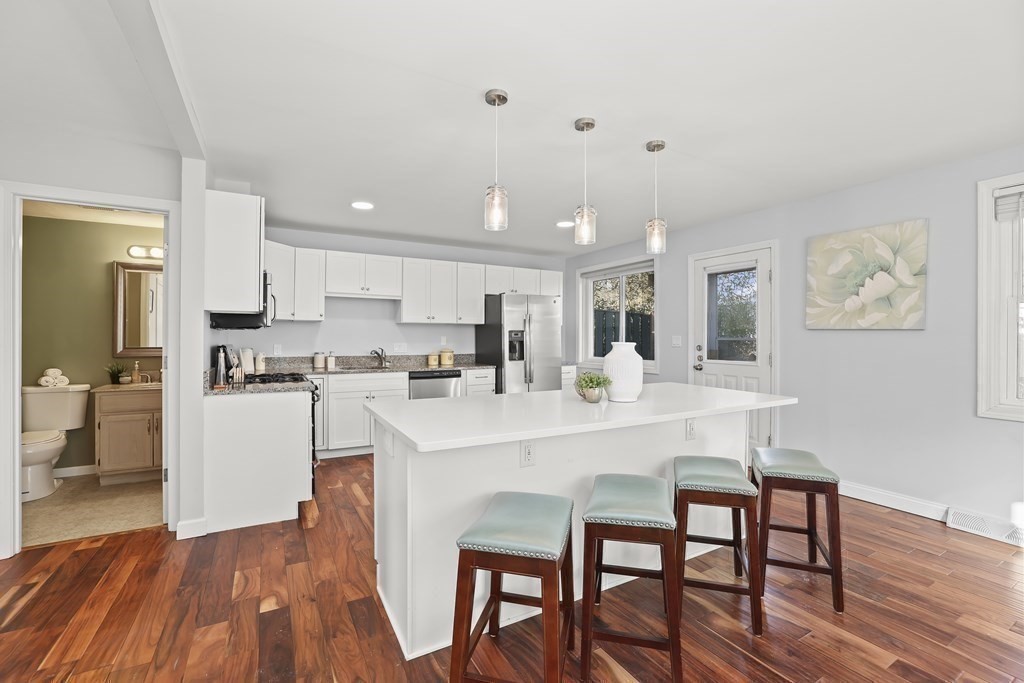 4 Rowe Court, Unit 4 Boston, MA 02131 - Photo 10 of 41 a kitchen with a dining table chairs refrigerator and cabinets