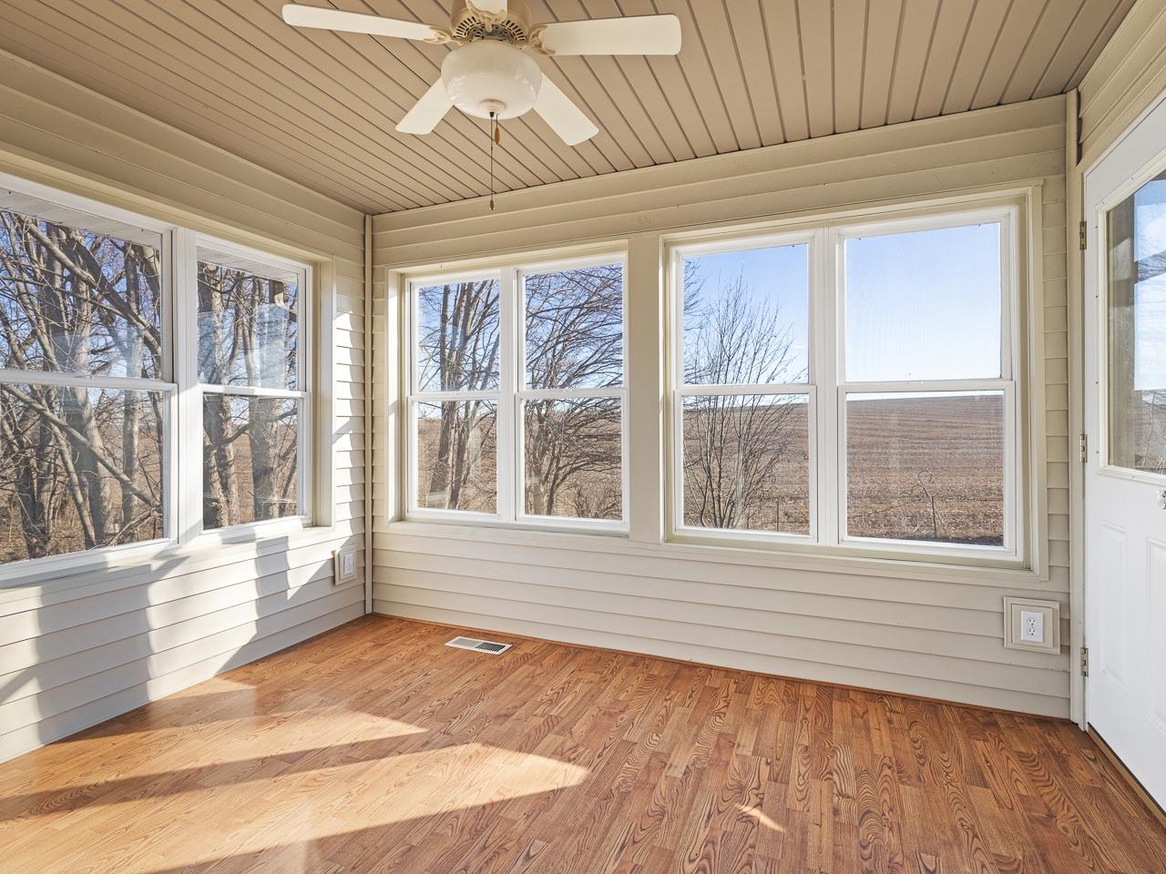 728 Westmore Road Davis, IL 61019 - Photo 15 of 45 a view of an empty room with a window and wooden floor