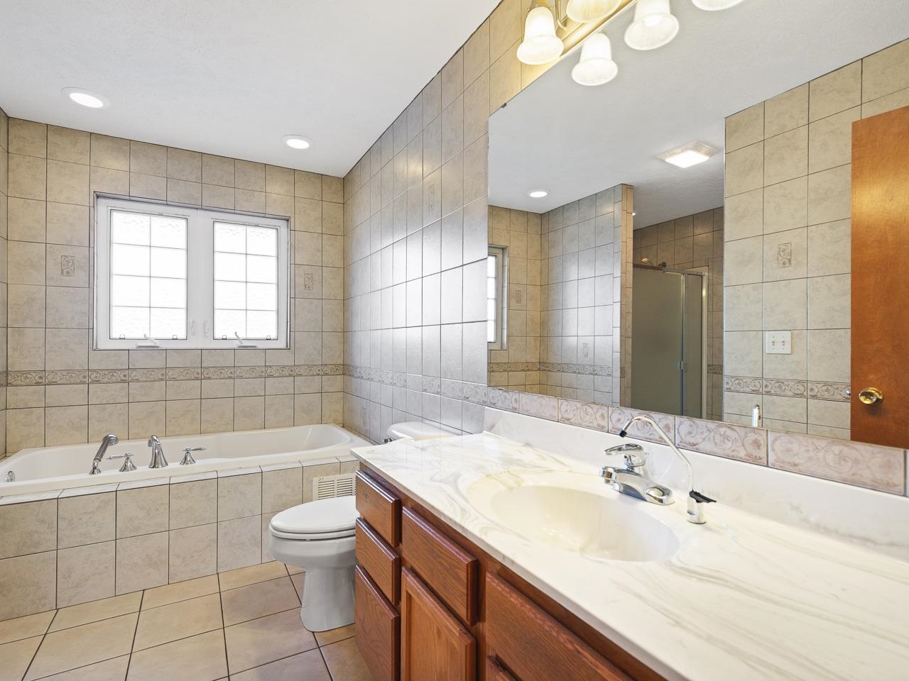 728 Westmore Road Davis, IL 61019 - Photo 17 of 45 a bathroom with a double vanity sink toilet mirror and bathtub