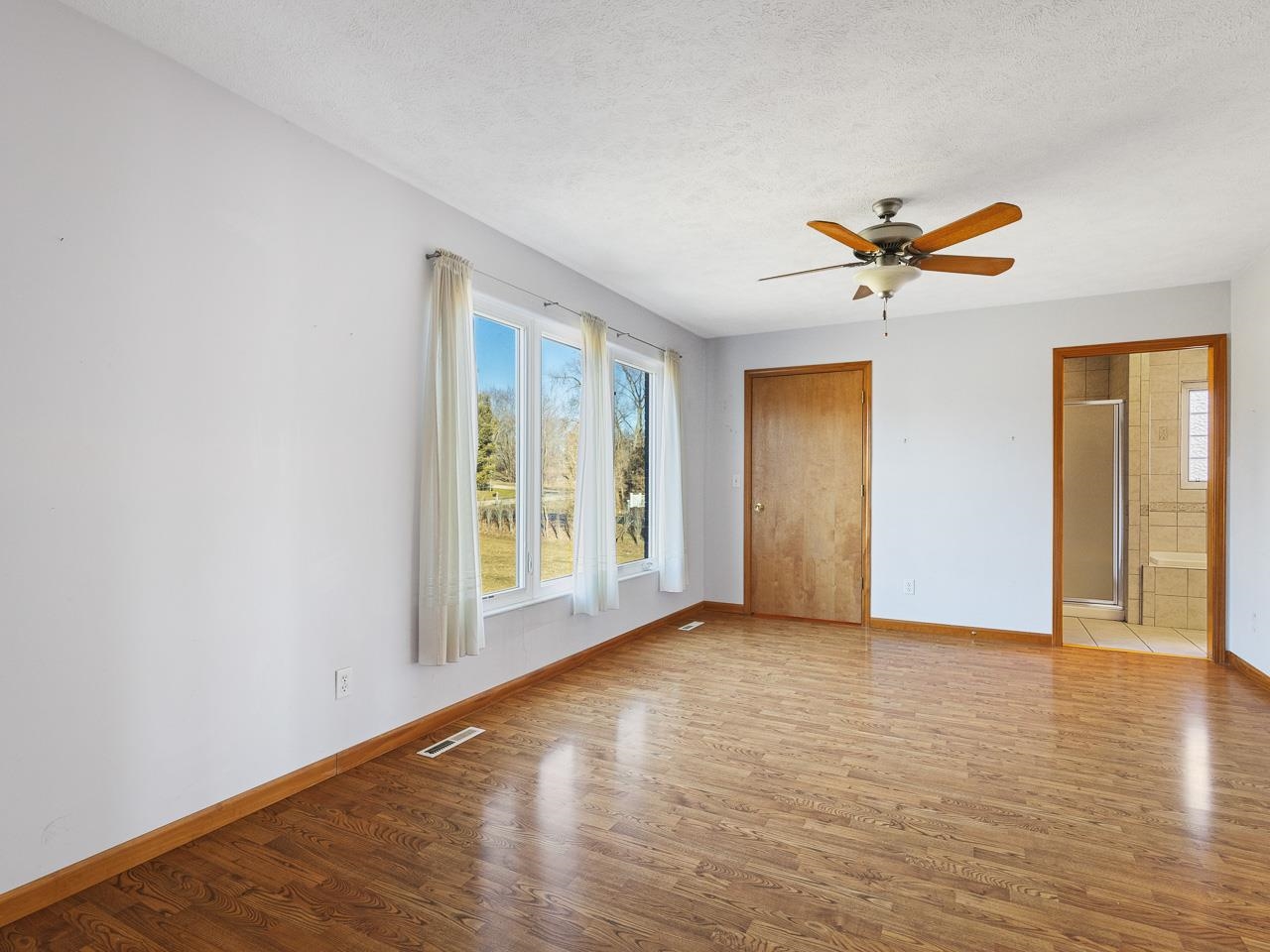 728 Westmore Road Davis, IL 61019 - Photo 21 of 45 a view of empty room with wooden floor and fan