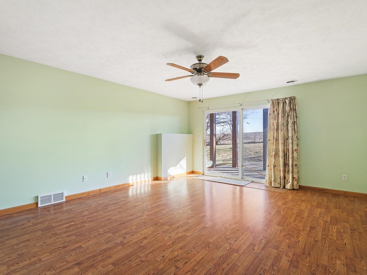 728 Westmore Road Davis, IL 61019 - Photo 23 of 45 a view of an empty room with wooden floor and a window