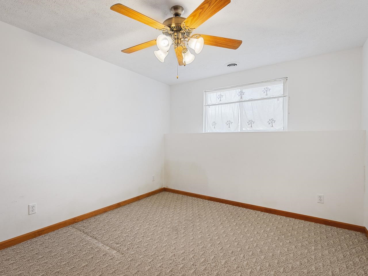 728 Westmore Road Davis, IL 61019 - Photo 27 of 45 an empty room with a chandelier fan and windows