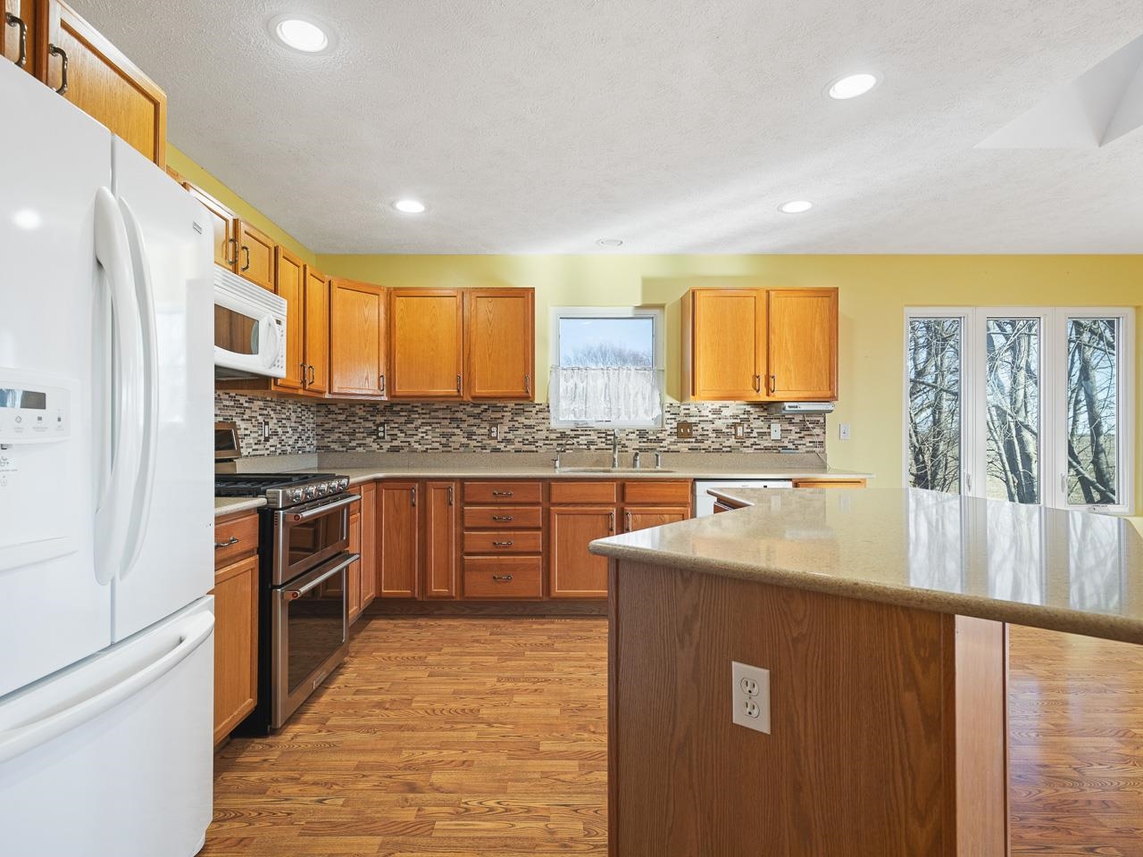 728 Westmore Road Davis, IL 61019 - Photo 8 of 45 a kitchen with stainless steel appliances granite countertop a sink stove and refrigerator