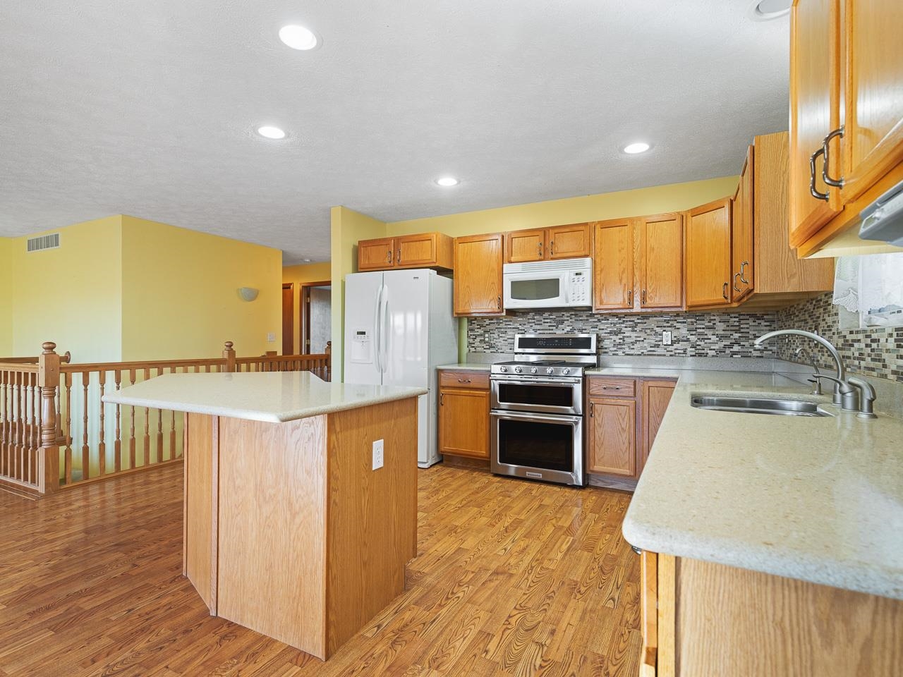 728 Westmore Road Davis, IL 61019 - Photo 9 of 45 a kitchen with stainless steel appliances granite countertop a stove a sink a refrigerator and a refrigerator