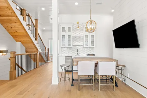 a view of a kitchen area with furniture and wooden floor