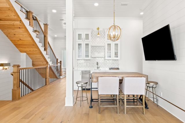 a view of a kitchen area with furniture and wooden floor