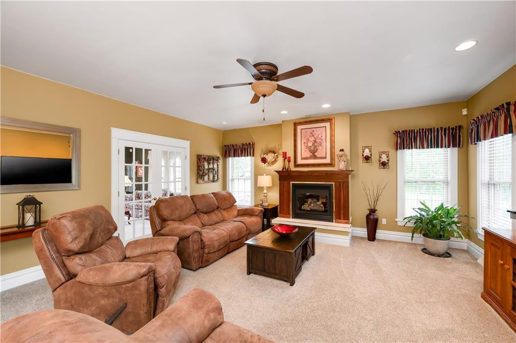 829 Hartzell School Road New Brighton, PA 15066 - Photo 14 of 50 a living room with furniture a fireplace and a flat screen tv