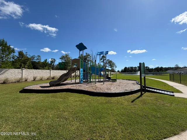 a view of a swimming pool with a yard