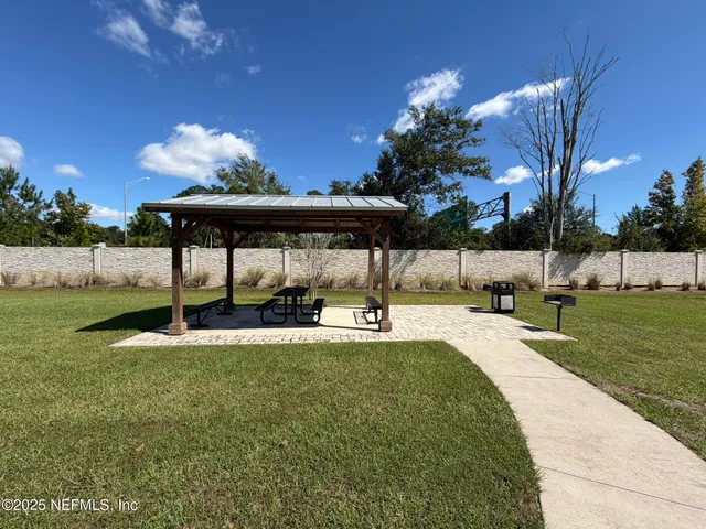 a view of a swimming pool with a yard