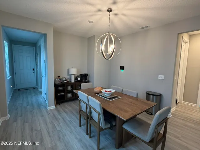 a view of a dining room furniture and wooden floor