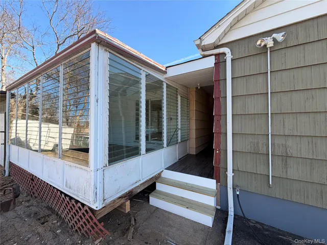 a view of a balcony with door and outdoor seating
