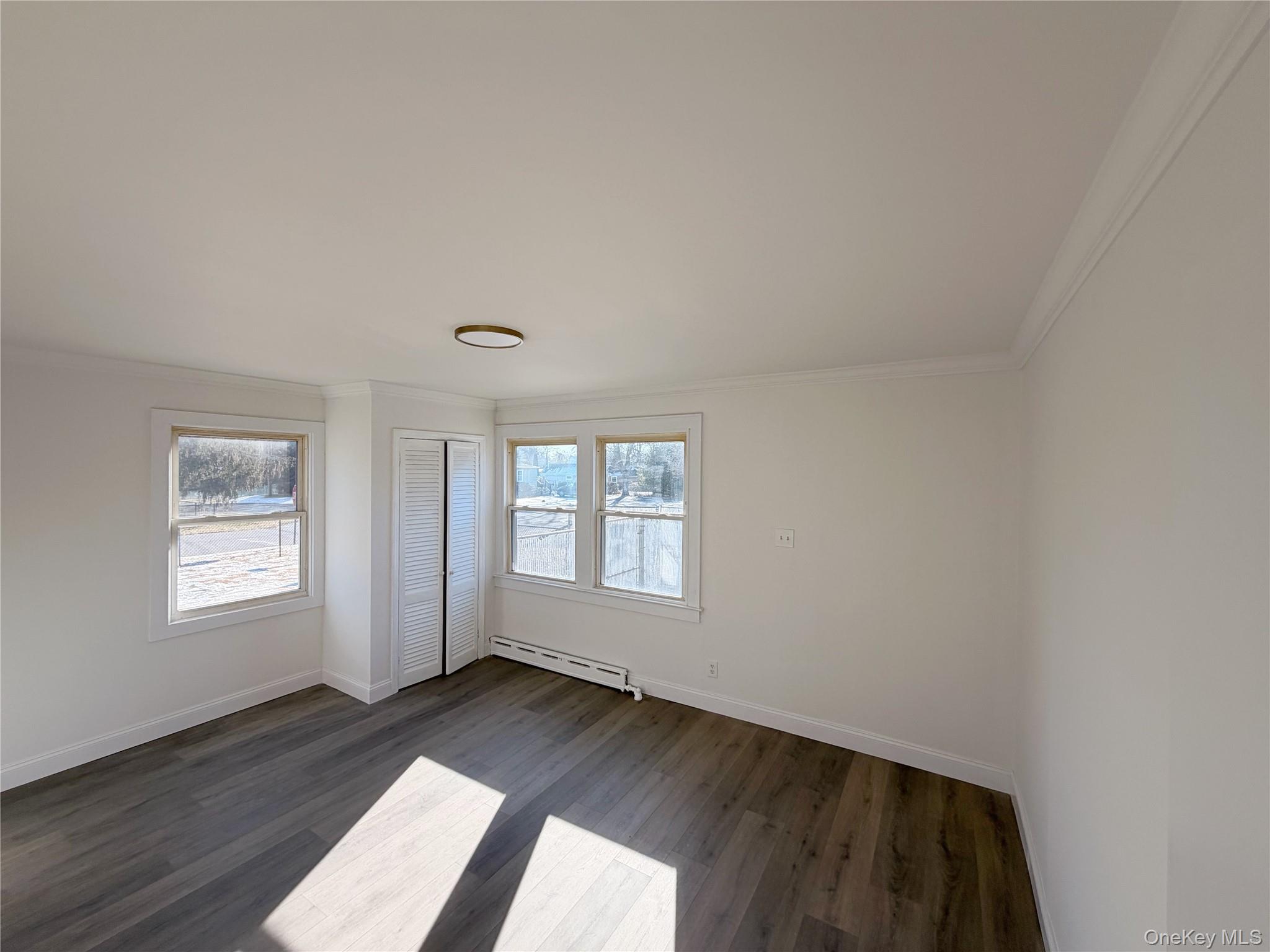 20 Bogota Road Mastic Beach, NY 11951 - Photo 8 of 34 an empty room with wooden floor and windows