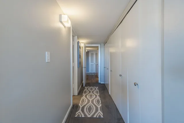 a view of hallway with wooden floor
