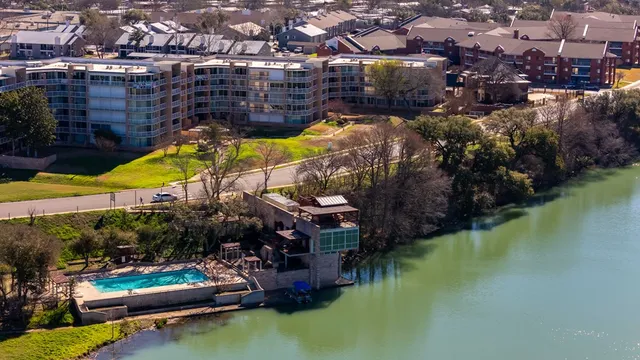 a view of swimming pool with outdoor seating and lake view