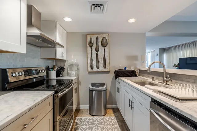 a kitchen that has a sink and a stove