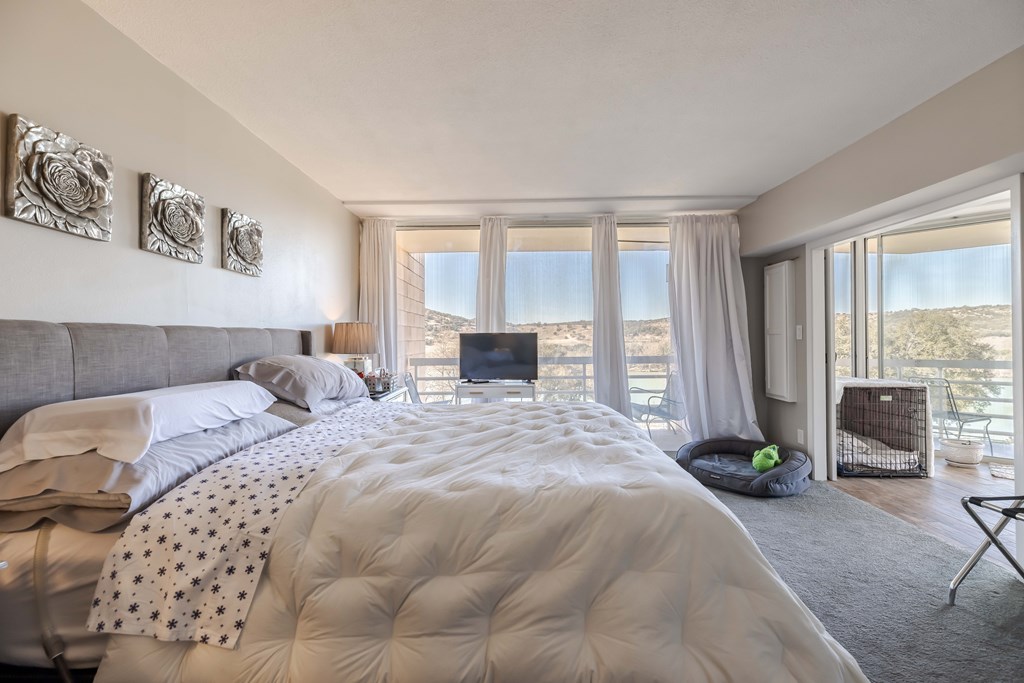 1006-3d Guadalupe Street Kerrville, TX 78028 - Photo 6 of 24 a bedroom with a bed and a large mirror on the dresser