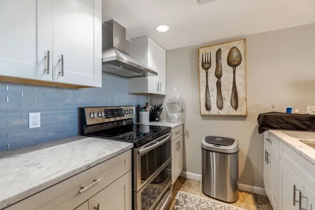 a kitchen with a sink and a stove top oven