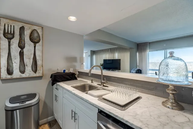 a kitchen with a sink a stove and cabinets
