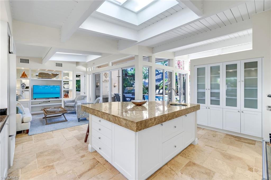 210 Central Avenue Naples, FL 34102 - Photo 11 of 50 a dining hall with stainless steel appliances granite countertop a kitchen island a stove and a sink large window