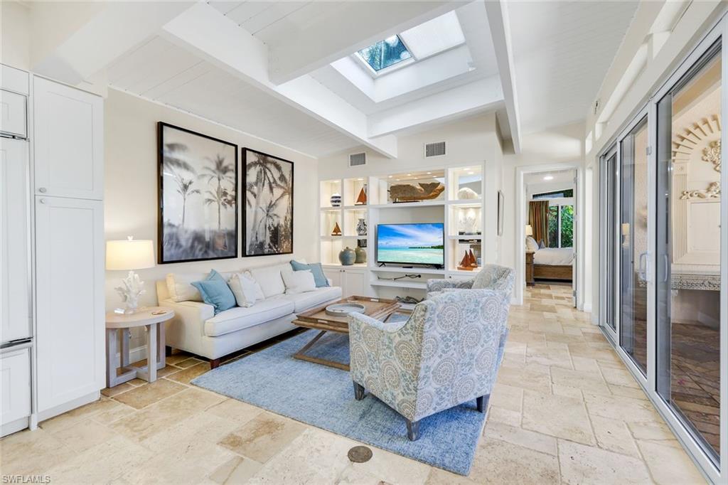 210 Central Avenue Naples, FL 34102 - Photo 13 of 50 a living room with furniture and a fireplace