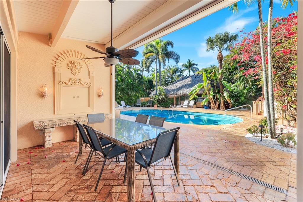 210 Central Avenue Naples, FL 34102 - Photo 15 of 50 a view of a patio with a table and chairs