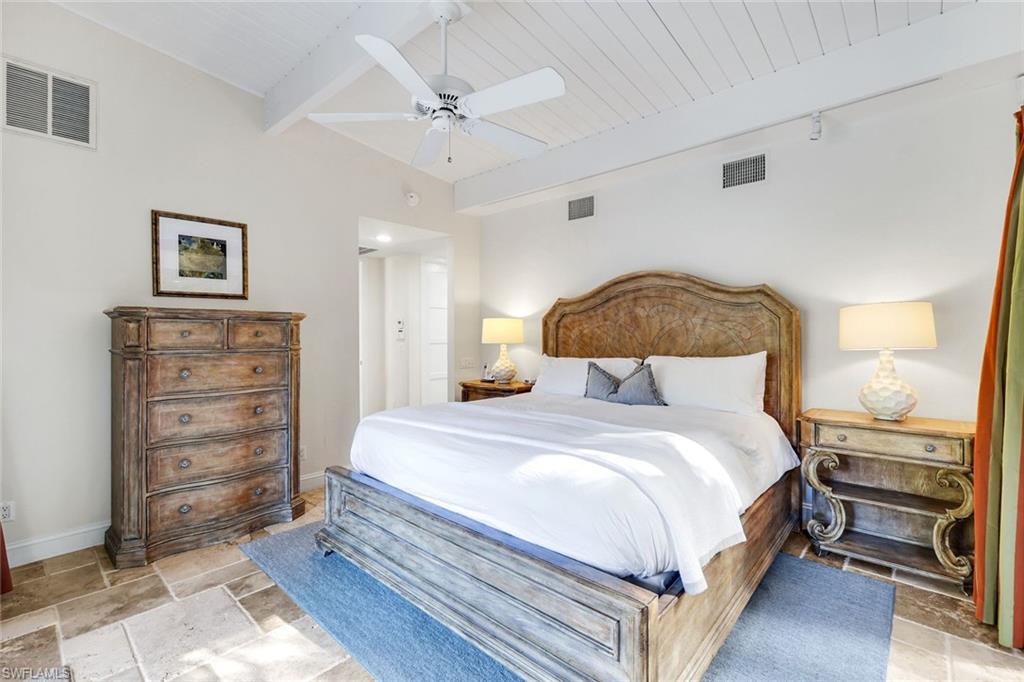 210 Central Avenue Naples, FL 34102 - Photo 17 of 50 a bedroom with a bed and a chandelier