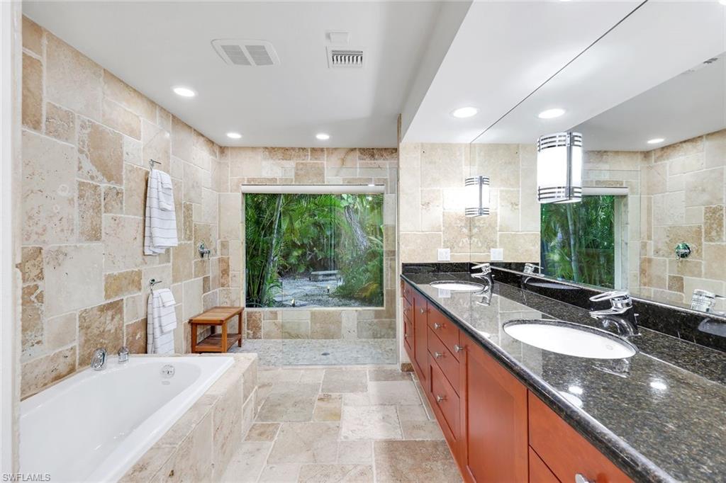 210 Central Avenue Naples, FL 34102 - Photo 18 of 50 a large bathroom with a granite countertop tub sink and a large mirror