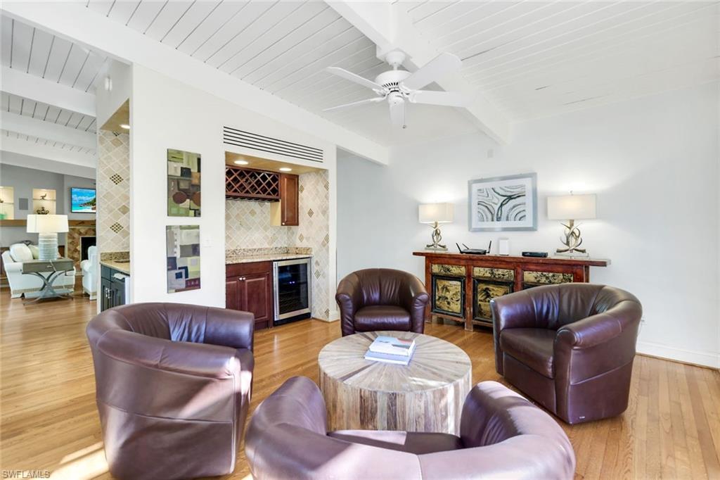 210 Central Avenue Naples, FL 34102 - Photo 23 of 50 a living room with furniture a fireplace and a large mirror