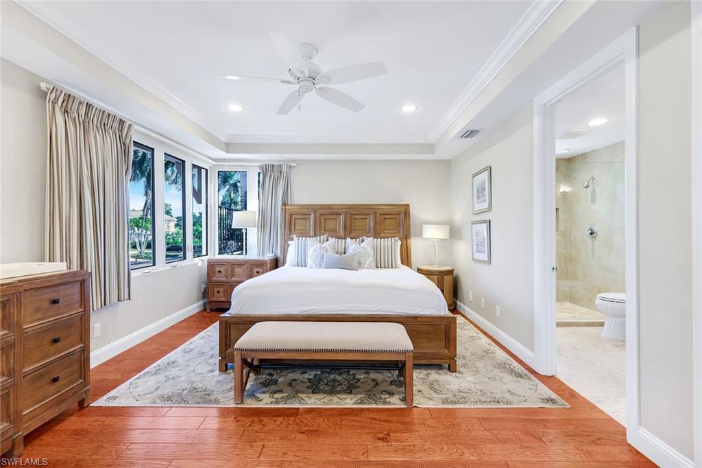 210 Central Avenue Naples, FL 34102 - Photo 28 of 50 a bedroom with a bed and glass window