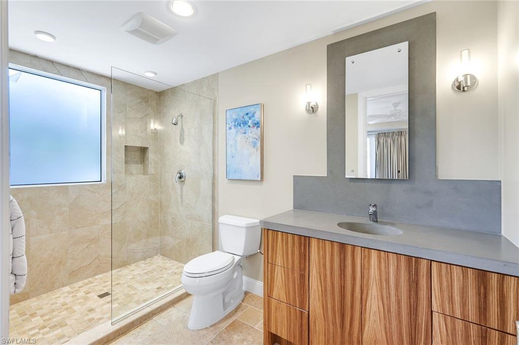 210 Central Avenue Naples, FL 34102 - Photo 29 of 50 a bathroom with a sink a toilet and shower