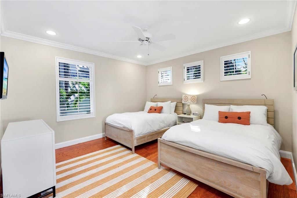 210 Central Avenue Naples, FL 34102 - Photo 30 of 50 a bedroom with two beds and a window